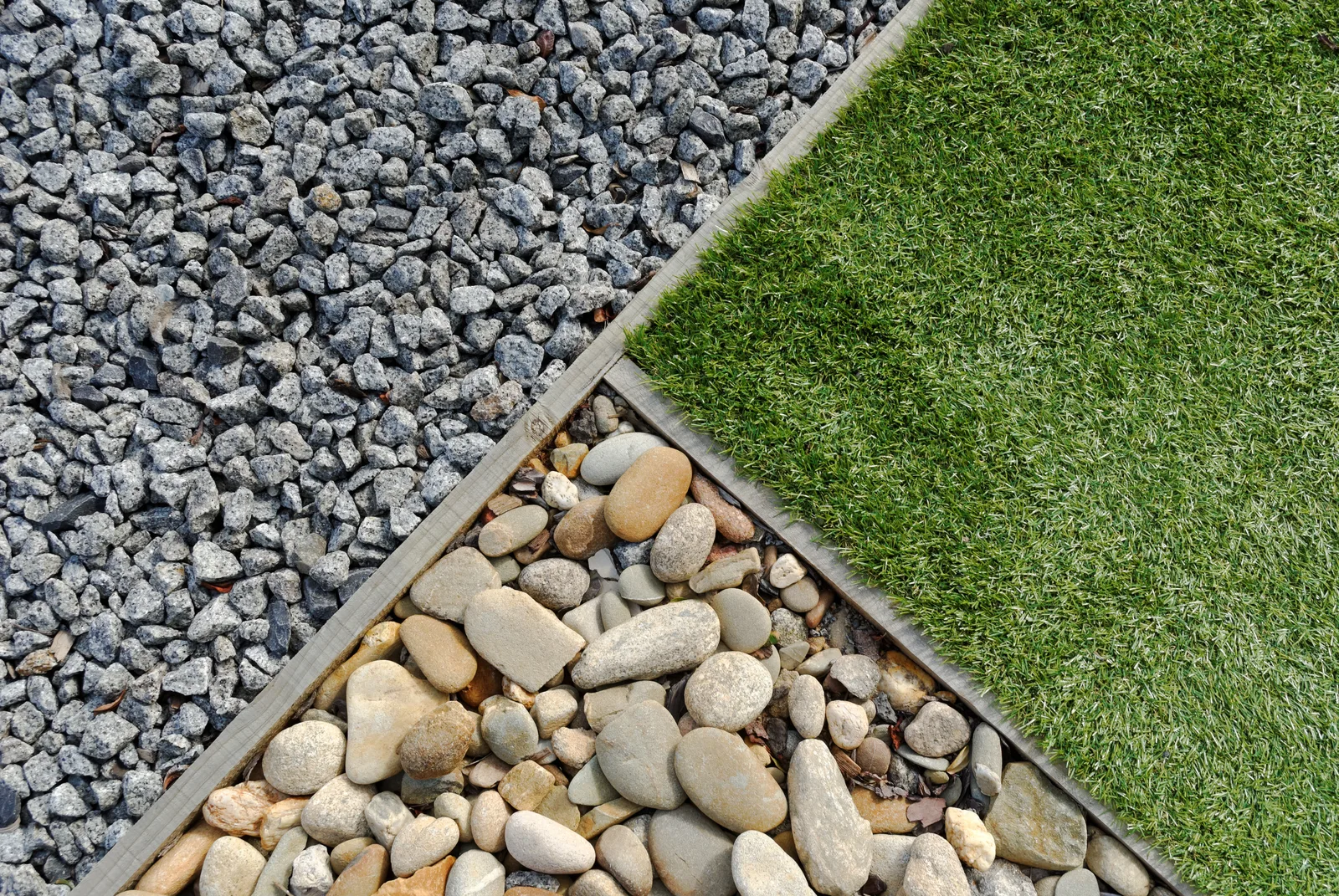 Decorative gravel, turf and river stone landscaping finishes used across residential projects in Canterbury