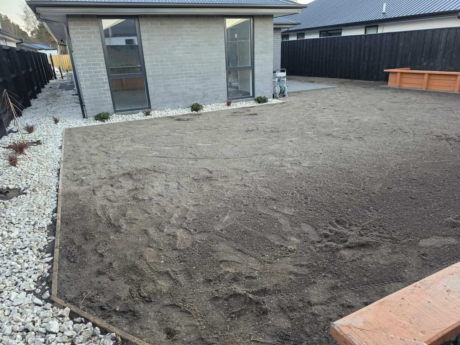 Rear yard with gravel borders, garden beds and site preparation at 25 Derbridge Street