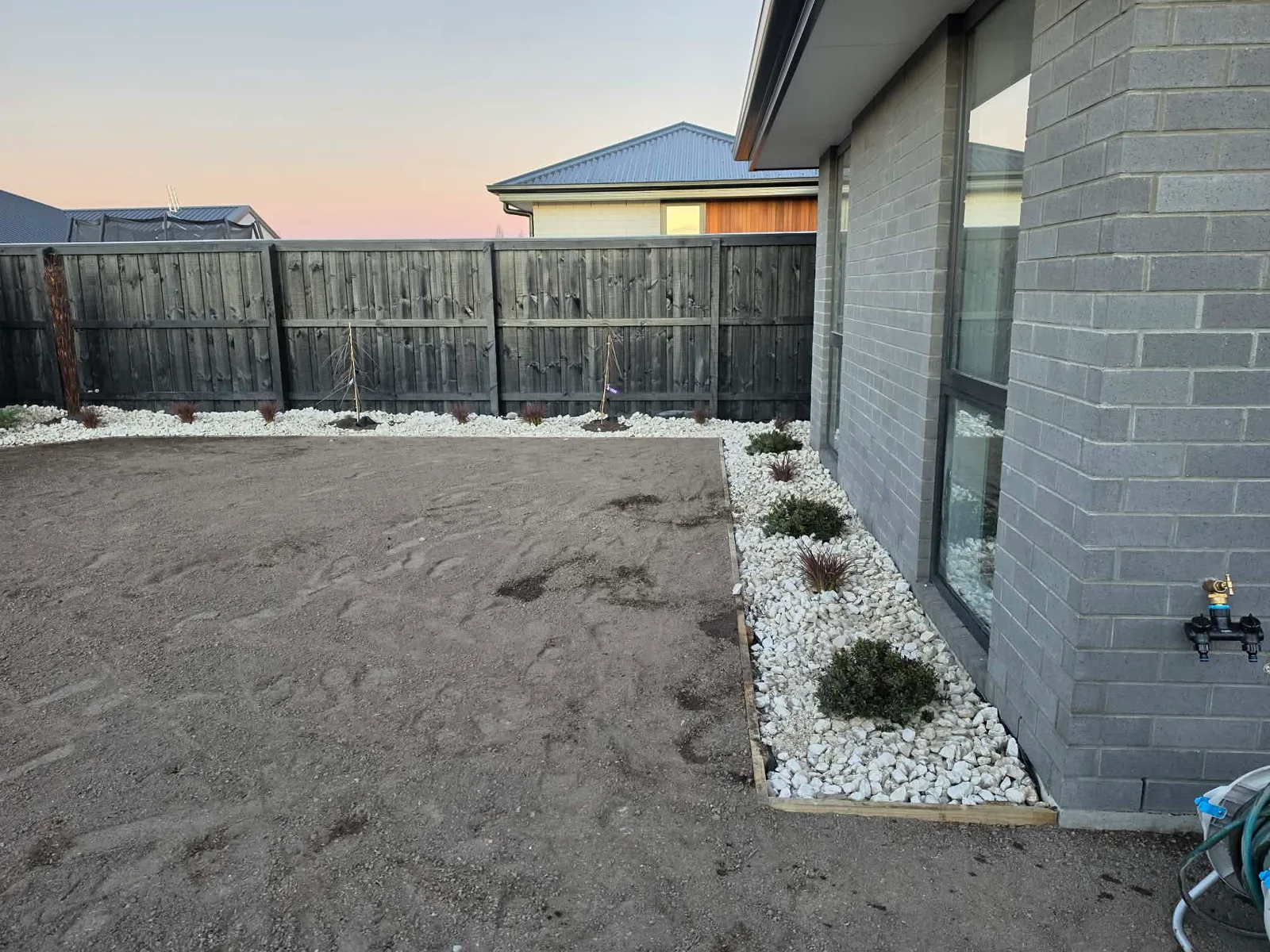 Aggregate and garden areas along the home exterior at 25 Derbridge Street, Christchurch