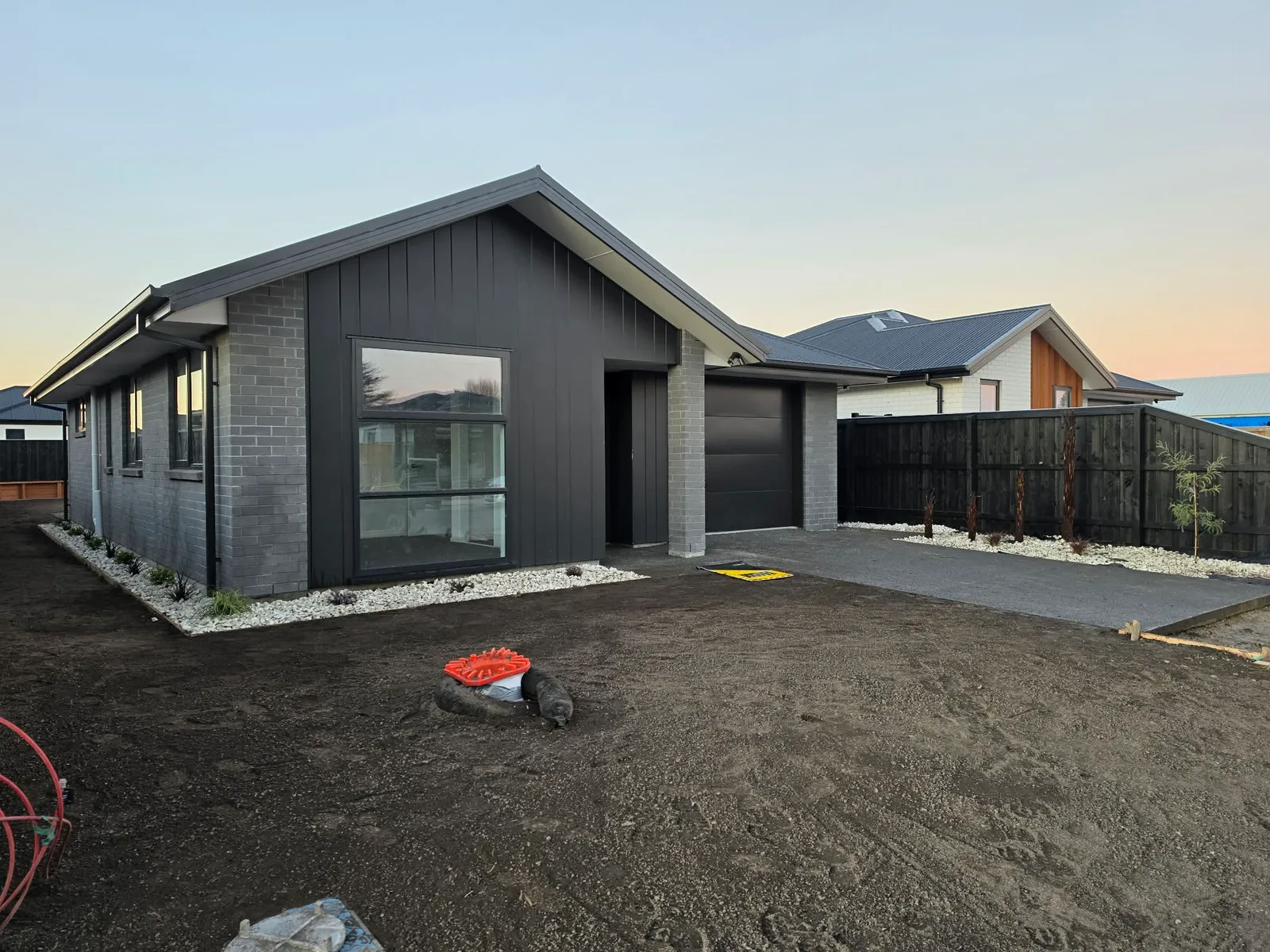 Rear yard garden beds and boundary fence at 25 Derbridge Street, Christchurch